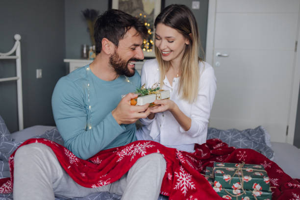 Christmas couple pictures in a cosy bed
